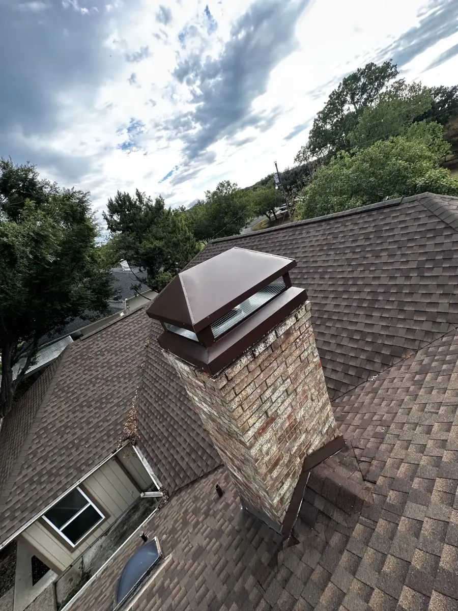 Completed brick chimney with new metal chimney cap and chase cover