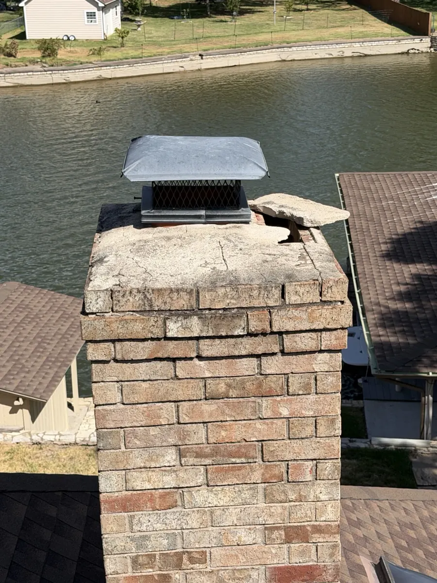 Brick chimney showing existing top and vent condition before preventative improvements