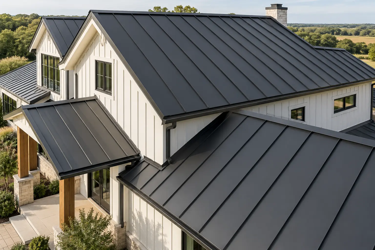Charcoal standing seam metal roof on a white farmhouse